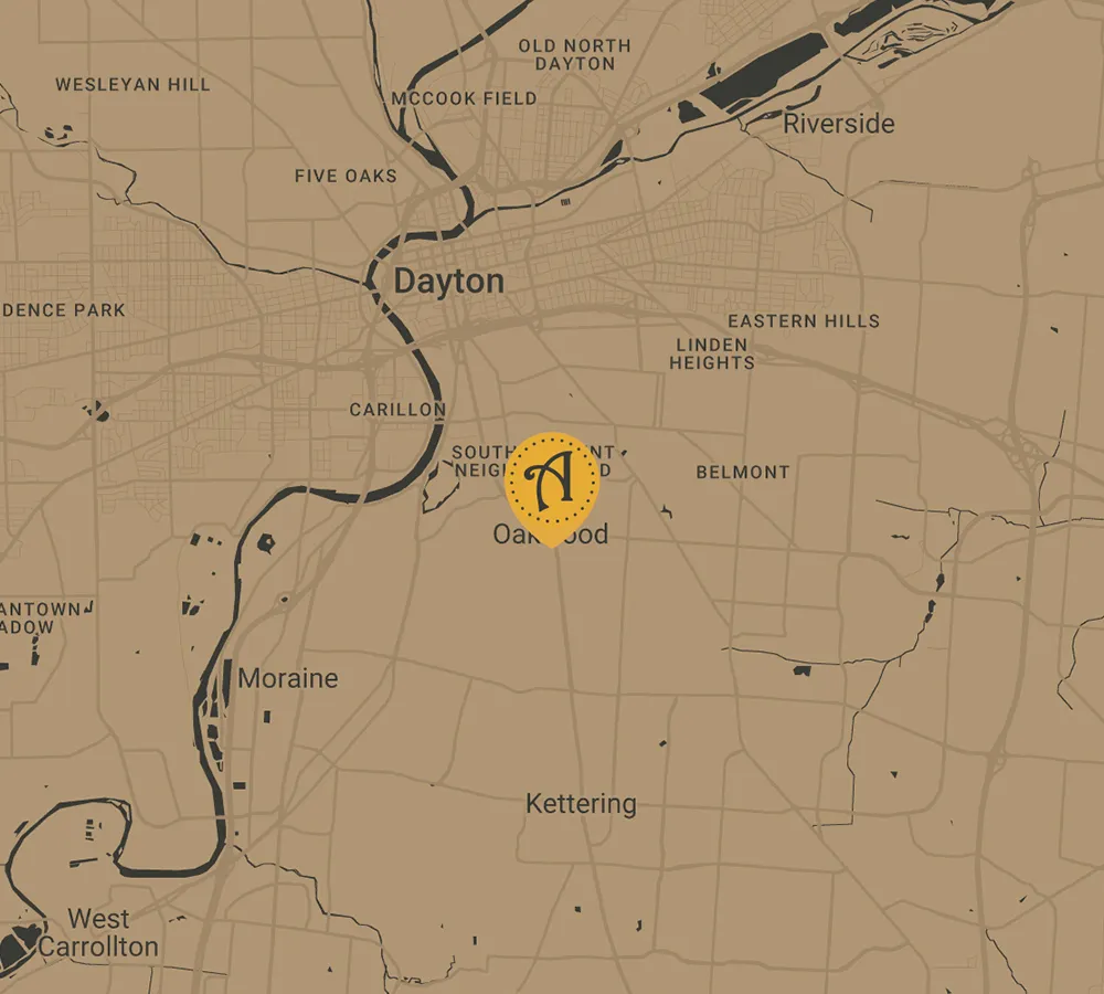 A map highlighting the Dayton area with a yellow circle and a black pin icon centered around Oakwood. Nearby areas include Kettering, Moraine, and Riverside, featuring a local bakery just a short distance away.
